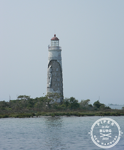 Deteriorating white brick lighthouse
