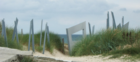 Pathway to the beach adorned with metal sculptures